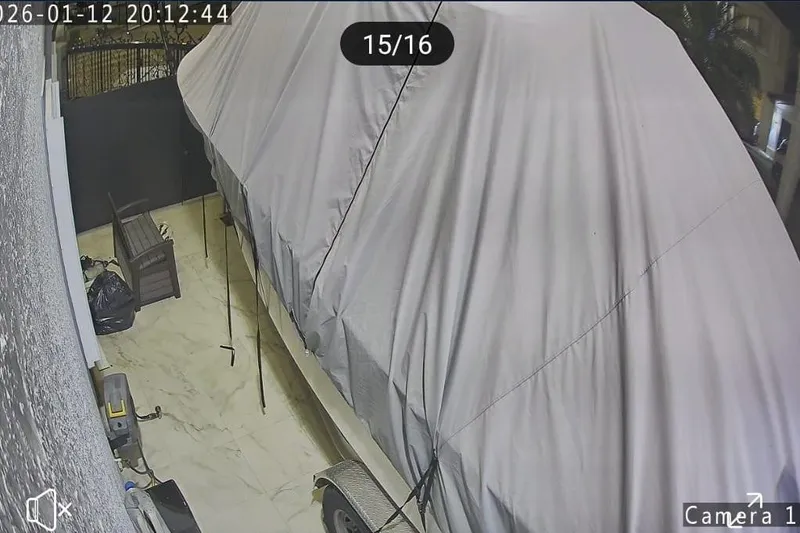 Slide: The Image of Covered 2004 Grady-White Chase 273 boat on trailer in a garage setting. - 13