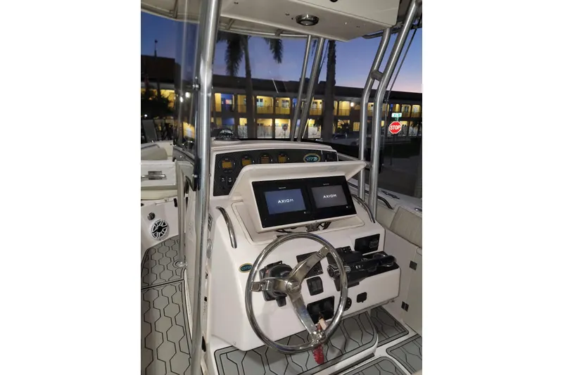 Slide: The Image of 2004 Grady-White Chase 273 boat cockpit with dual Axiom displays at dusk. - 11