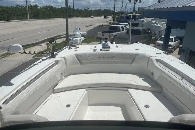 Slide: The Image of 2024 World Cat 295 CC boat with spacious seating, docked near a road. - 4