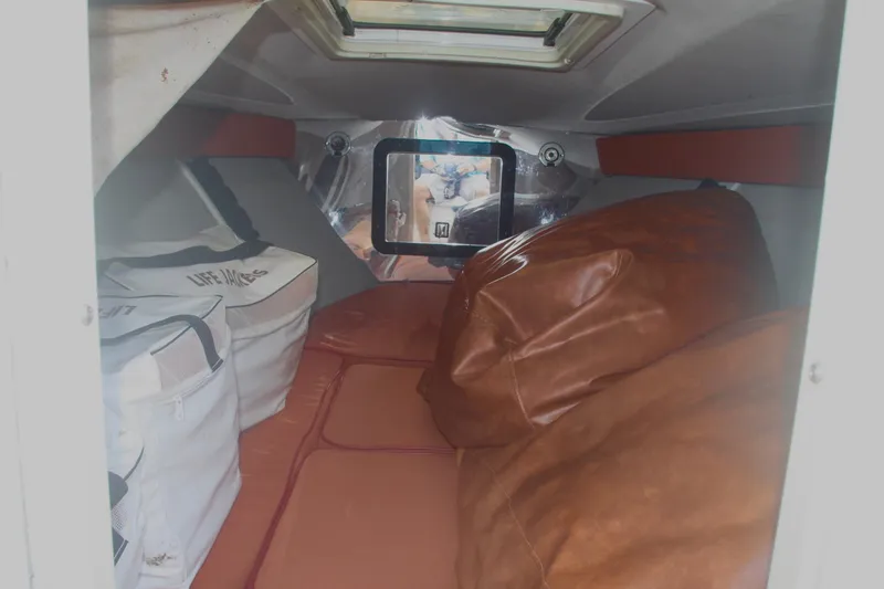 Slide: The Image of Interior cabin of a 1996 Marlago 35 boat with cushions and life jackets. - 9