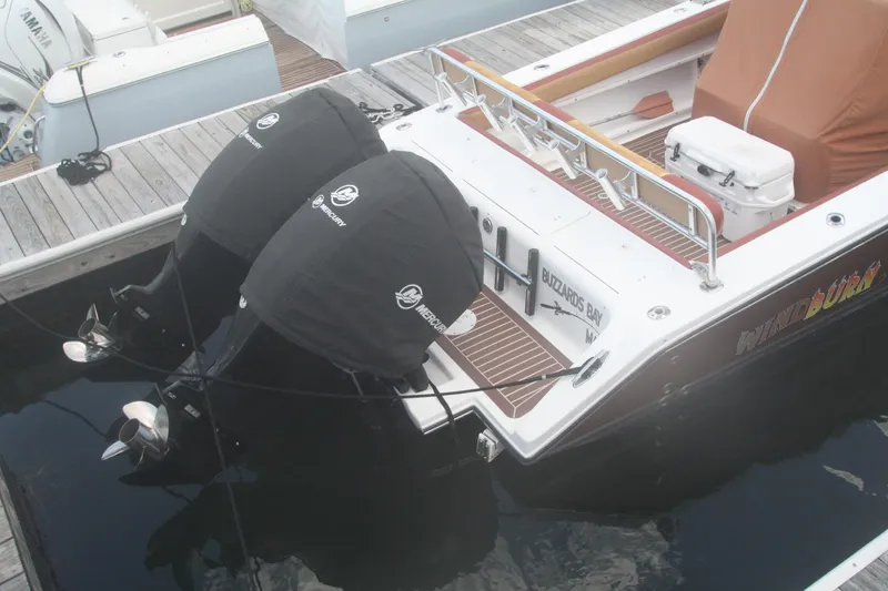 Slide: The Image of 1996 Marlago 35 boat with dual Mercury outboard engines docked at marina. - 3