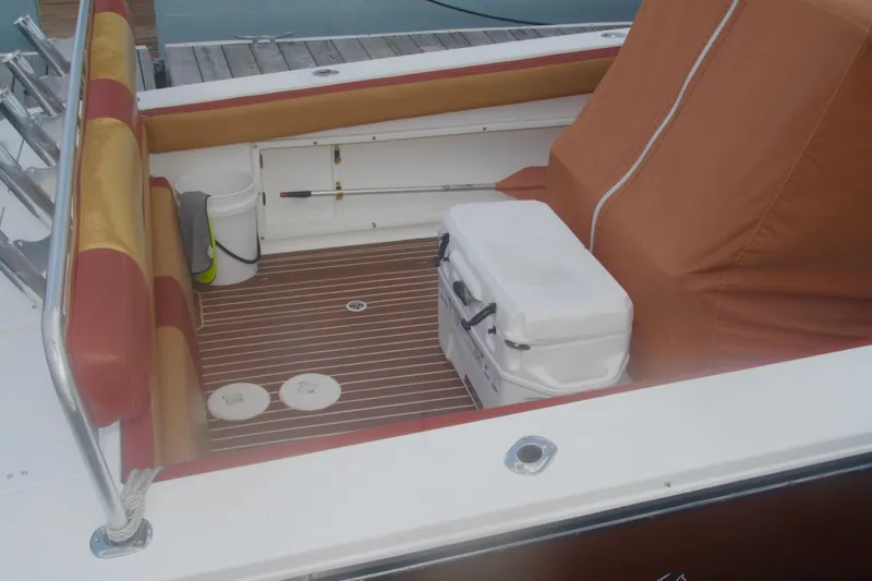 Slide: The Image of Interior of a 1996 Marlago 35 boat with seating and cooler on deck. - 7