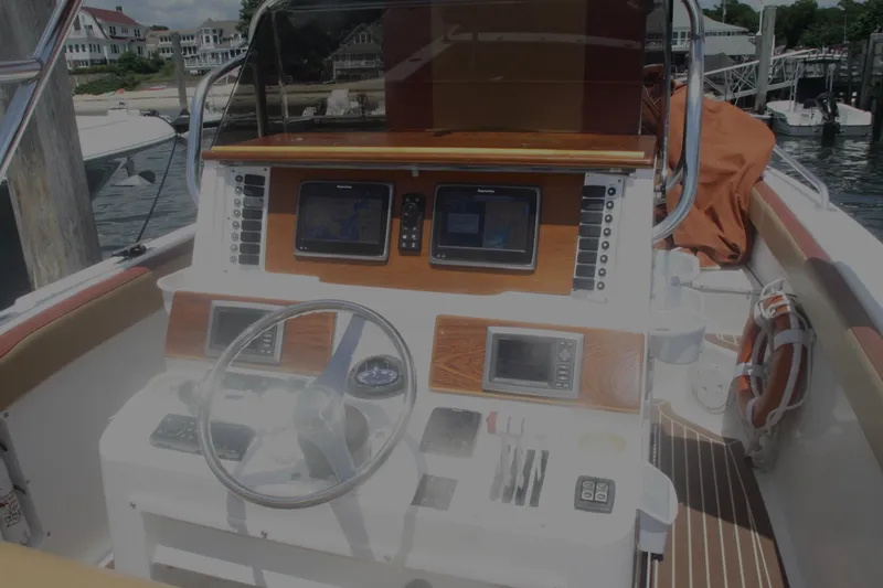 Slide: The Image of Cockpit of a 1996 Marlago 35 boat with navigation equipment and steering wheel. - 5