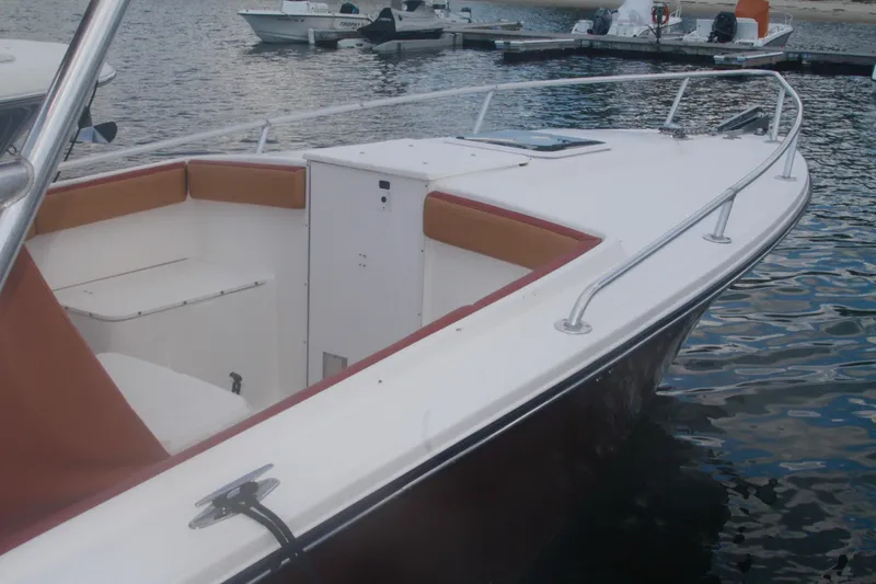 Slide: The Image of 1996 Marlago 35 boat with spacious deck and seating, docked by the water. - 10