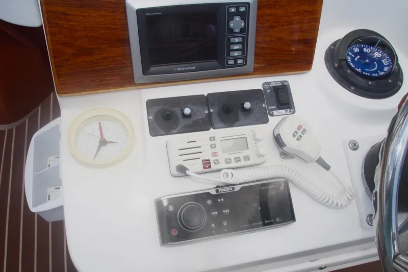 Slide: The Image of Control panel of a 1996 Marlago 35 boat with navigation and communication equipment. - 12