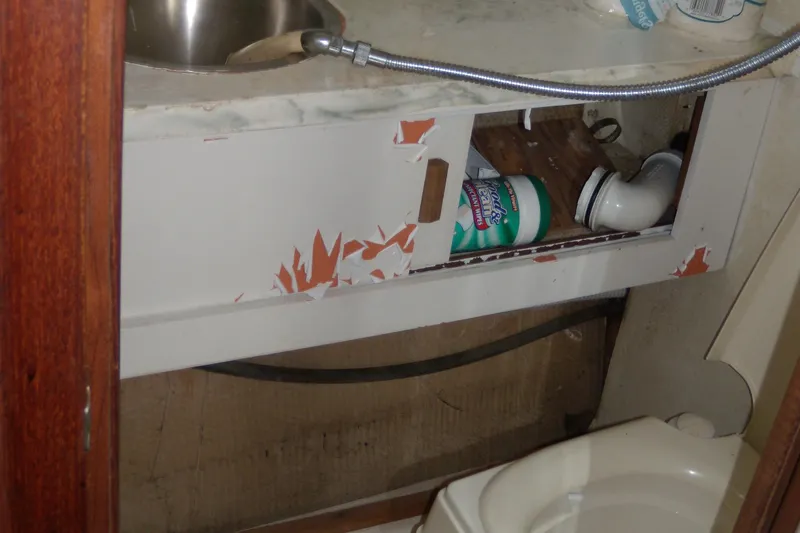 Slide: The Image of The image shows a small bathroom on a boat with a sink and a toilet. - 15