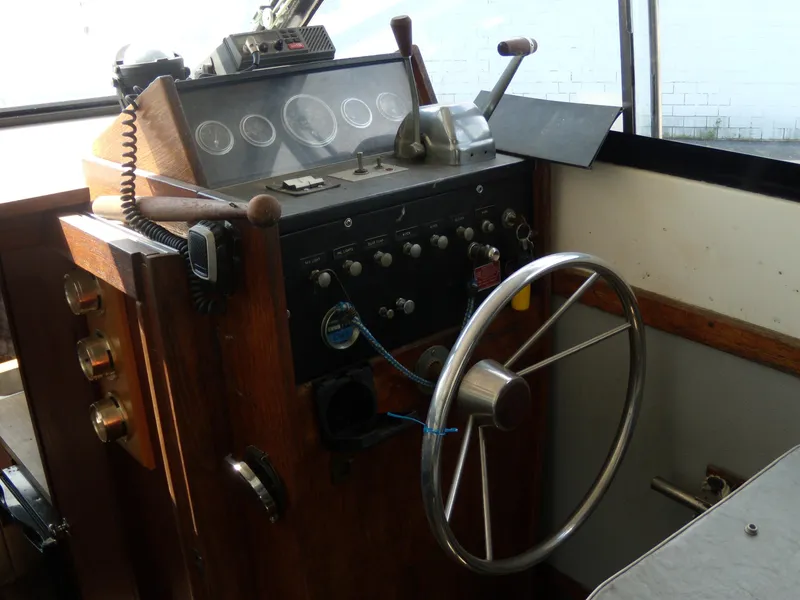 Slide: The Image of The image shows the helm of a 1973 Trojan F-32 with a steering wheel and instruments. - 5