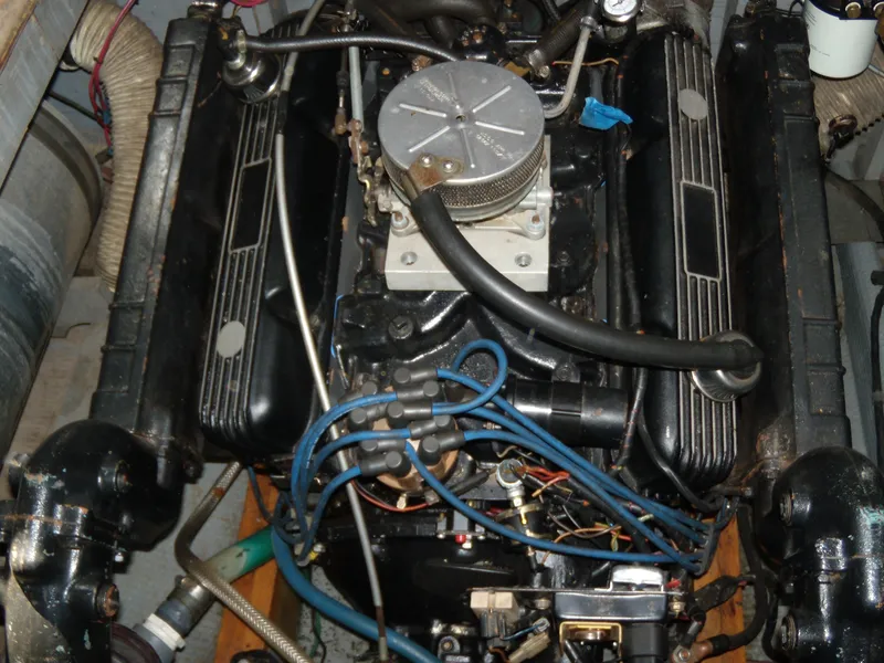 Slide: The Image of An engine compartment with a well-maintained engine, surrounded by hoses and wires. - 10