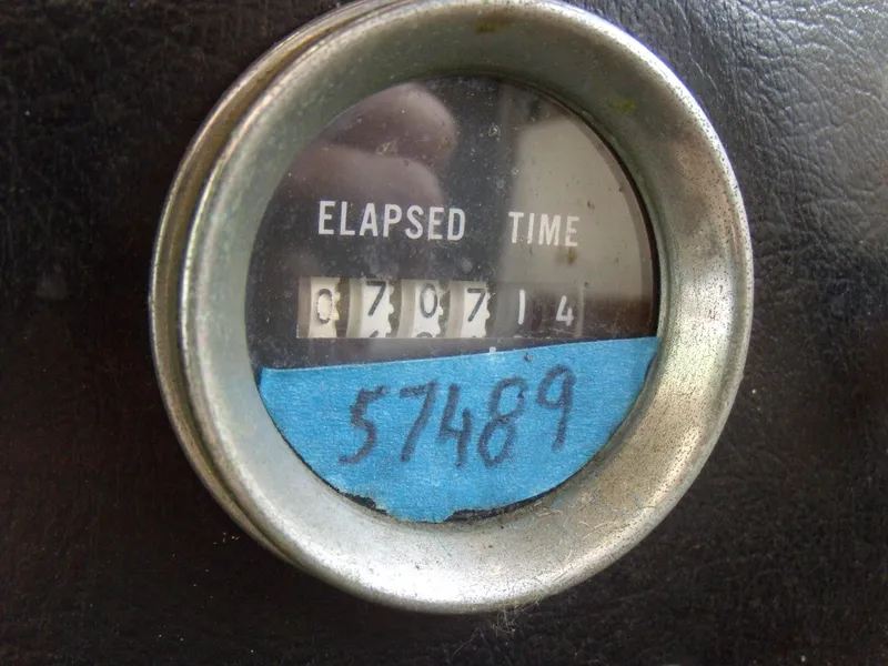 Slide: The Image of A round gauge displays "Elapsed Time" with a reading of 3707.4. Below, 57489 is handwritten. - 12