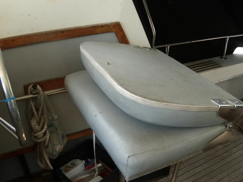Slide: The Image of A gray seat on a boat with wood and metal accents. - 6