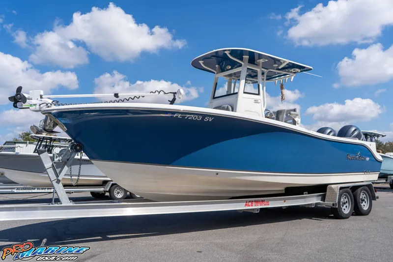 Slide: The Image of 2021 NauticStar 2602 Legacy boat on trailer under blue sky. - 6
