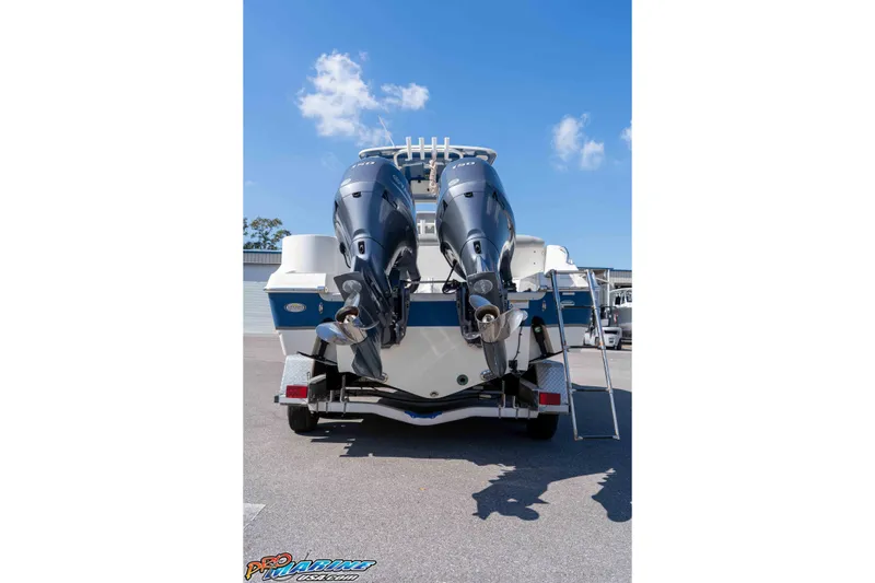 Slide: The Image of 2021 NauticStar 2602 Legacy boat with dual outboard motors on a trailer. - 13