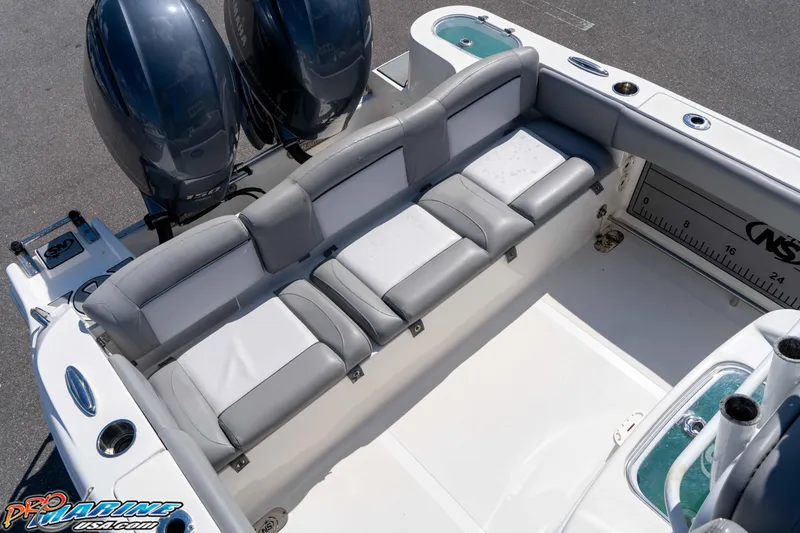 Slide: The Image of 2021 NauticStar 2602 Legacy boat interior with seating and dual engines. - 20