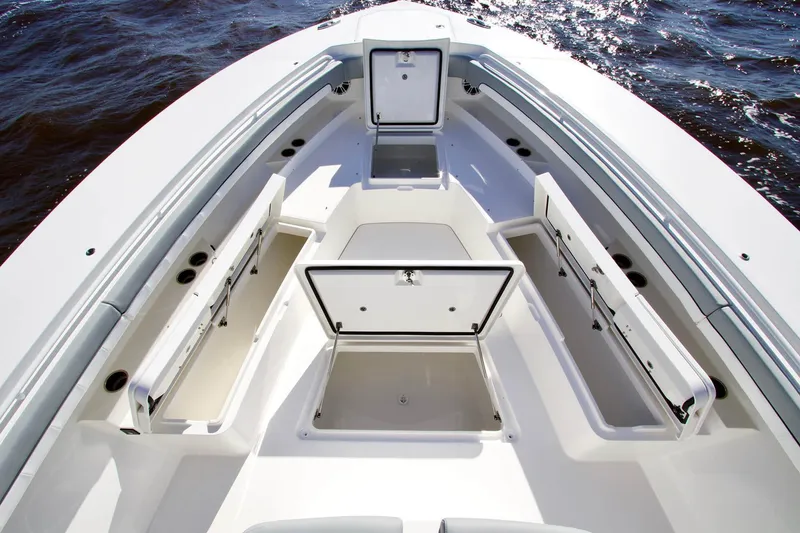 Slide: The Image of Bow storage compartments on a 2027 Regulator 41 boat, open on calm water. - 10