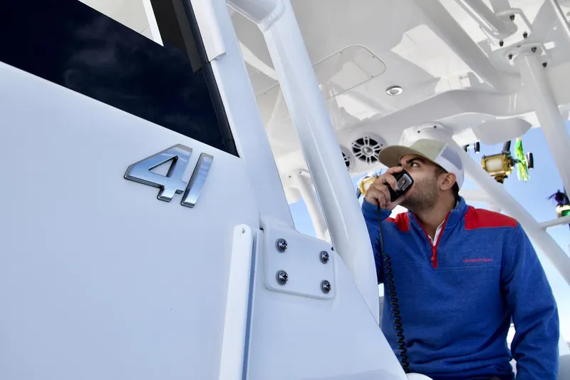 Slide: The Image of Man using radio on 2027 Regulator 41 boat, showcasing modern design and technology. - 7