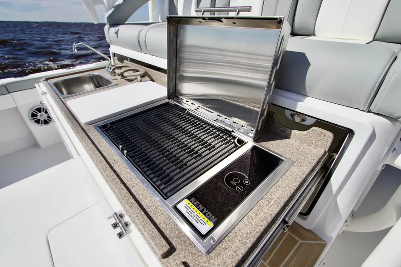 Slide: The Image of Outdoor kitchen on 2027 Regulator 41 boat with grill, sink, and cutting board. - 3