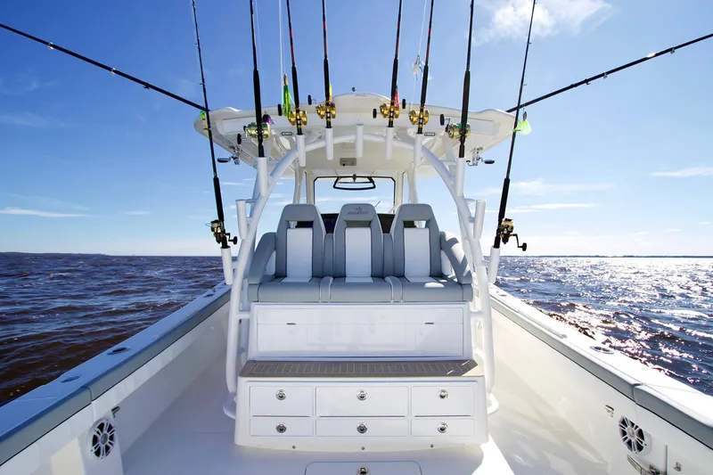Slide: The Image of 2027 Regulator 41 boat with fishing rods on open water under clear sky. - 5