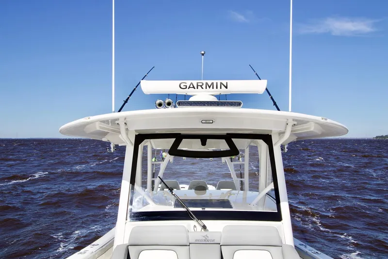 Slide: The Image of 2027 Regulator 41 boat with Garmin equipment on open water under clear blue sky. - 9