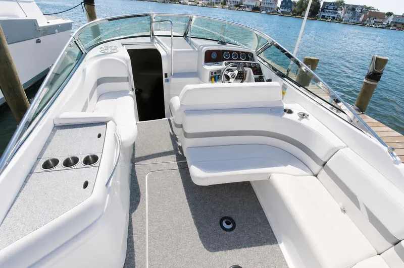 Slide: The Image of The image shows the cockpit of a 2004 Formula 280 Sun Sport with white upholstery and a sleek dashboard. - 4