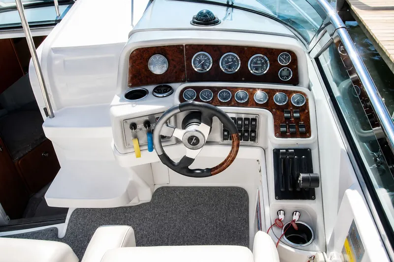 Slide: The Image of The cockpit of a 2004 Formula 280 Sun Sport with a sleek dashboard and multiple instruments. - 10