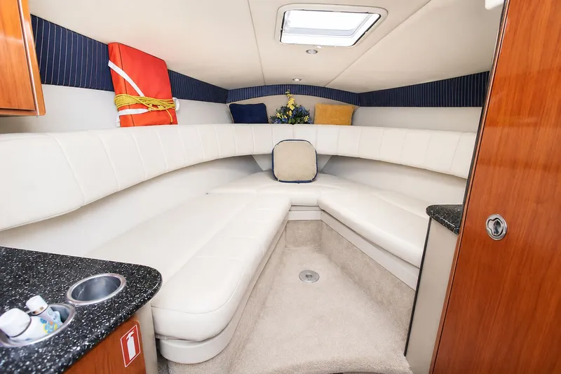 Slide: The Image of Interior of the 2004 Formula 280 Sun Sport with white upholstery and wood accents. - 15