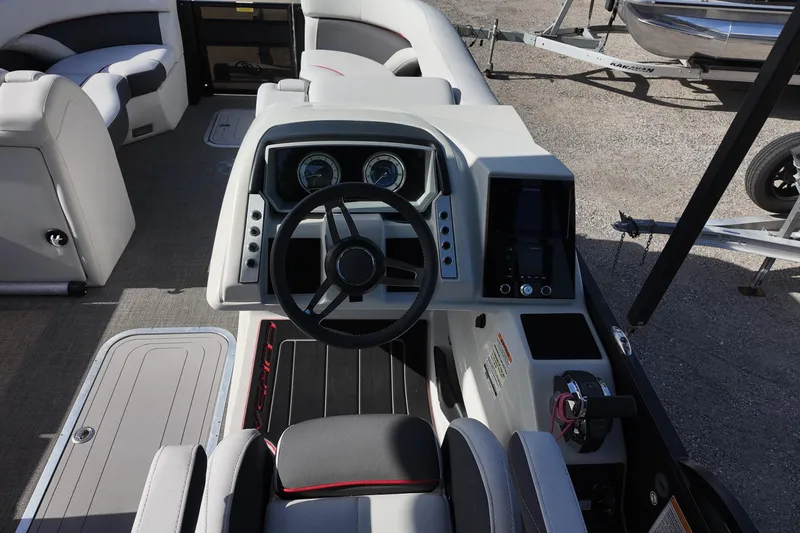 Slide: The Image of 2022 Barletta Corsa 23U boat cockpit with modern steering and control panel. - 12