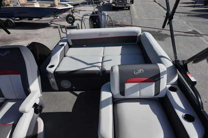 Slide: The Image of 2022 Barletta Corsa 23U pontoon boat interior with plush seating and cup holders. - 11