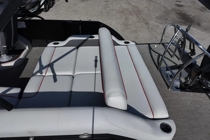 Slide: The Image of 2022 Barletta Corsa 23U boat interior with white seating and red accents. - 15