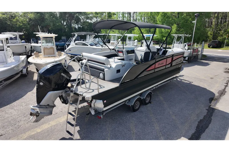 Slide: The Image of 2022 Barletta Corsa 23U pontoon boat with Mercury outboard engine on trailer. - 5