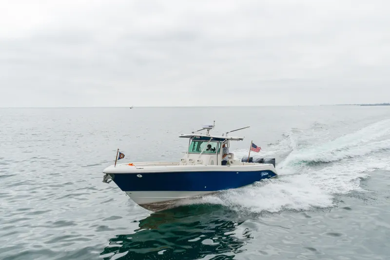 Slide: The Image of 2009 Everglades 350 Center Console boat cruising on open water. - 13
