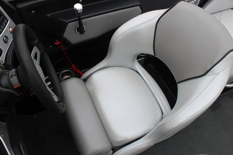 Slide: The Image of 2017 MasterCraft NXT22 boat interior with steering wheel and white captain's seat. - 29