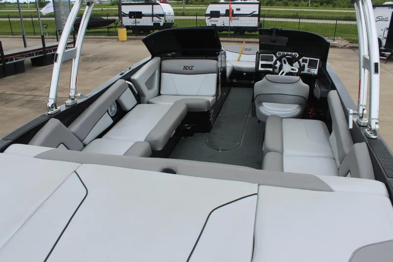 Slide: The Image of 2017 MasterCraft NXT22 boat interior with gray seating and modern dashboard. - 10