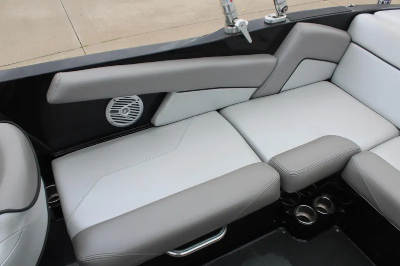 Slide: The Image of 2017 MasterCraft NXT22 boat interior with gray and white seating and built-in speaker. - 18