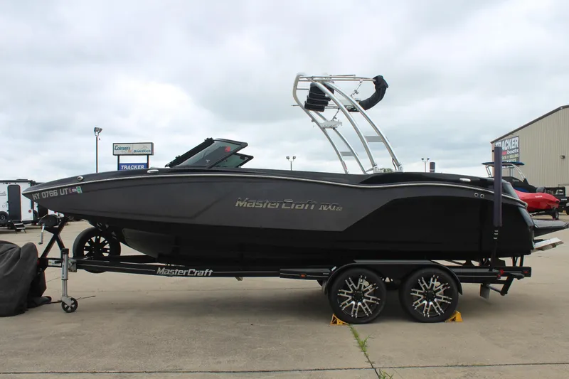 Slide: The Image of 2017 MasterCraft NXT22 boat on trailer, black exterior, parked outdoors. - 5