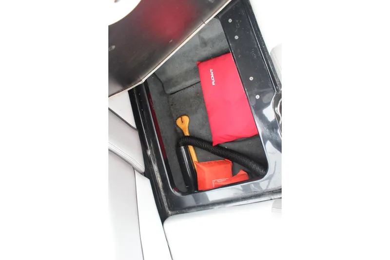 Slide: The Image of Storage compartment of a 2017 MasterCraft NXT22 boat with safety equipment. - 21