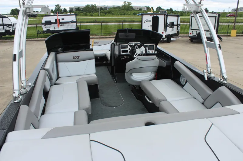 Slide: The Image of 2017 MasterCraft NXT22 boat interior with spacious seating and modern dashboard. - 11