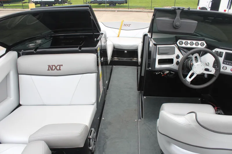 Slide: The Image of 2017 MasterCraft NXT22 boat interior with steering wheel and seating. - 23