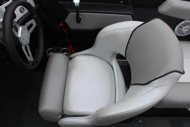 Slide: The Image of 2017 MasterCraft NXT22 boat interior with steering wheel and cushioned seat. - 28