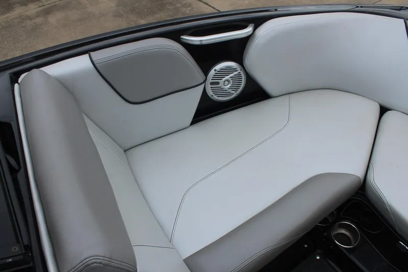 Slide: The Image of 2017 MasterCraft NXT22 boat interior with gray and white seating and speaker detail. - 33