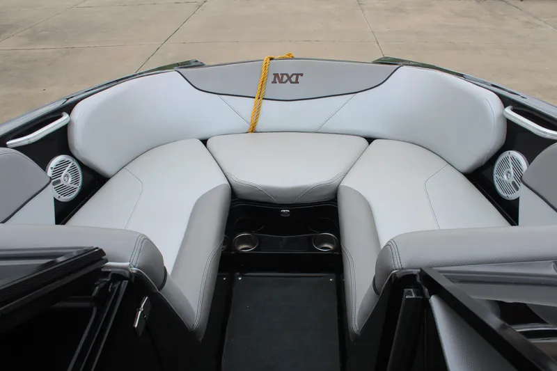 Slide: The Image of 2017 MasterCraft NXT22 boat interior with gray seating and cup holders. - 32
