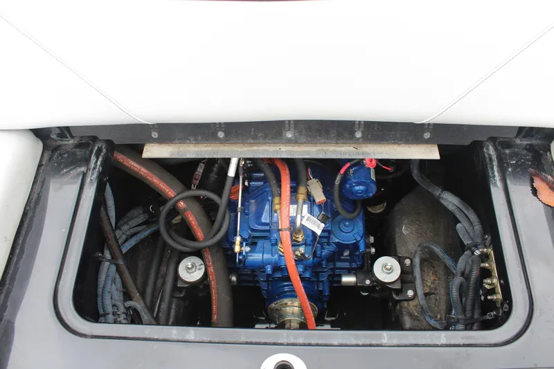 Slide: The Image of 2017 MasterCraft NXT22 engine compartment with visible blue engine and wiring. - 22