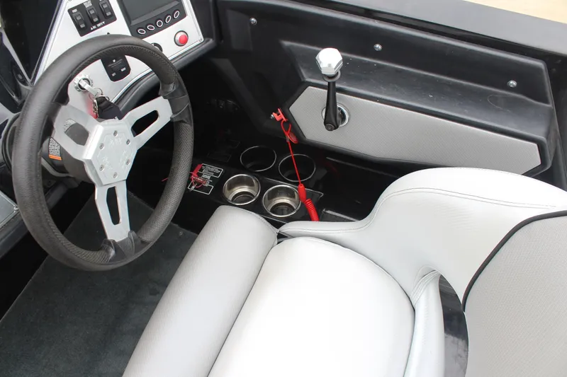 Slide: The Image of Interior of a 2017 MasterCraft NXT22 boat featuring steering wheel and control panel. - 27