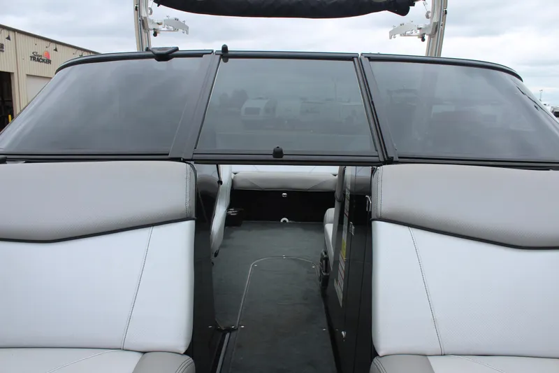 Slide: The Image of 2017 MasterCraft NXT22 boat interior with gray and white seating, windshield view. - 36