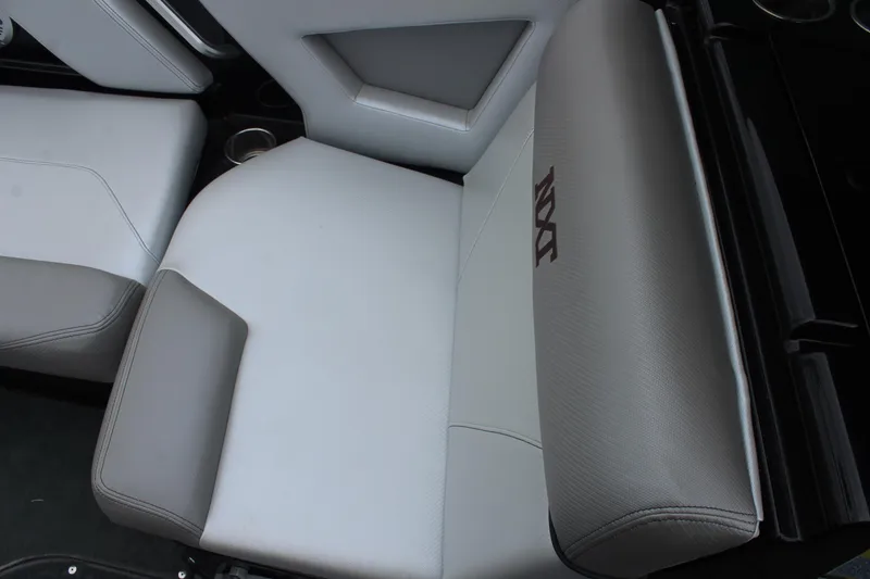 Slide: The Image of 2017 MasterCraft NXT22 boat interior seating with gray upholstery and cup holders. - 30