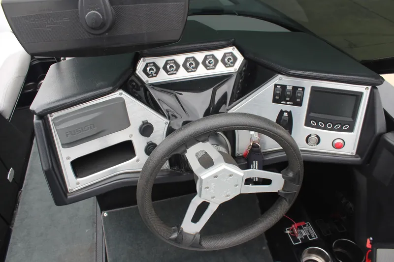 Slide: The Image of Dashboard of a 2017 MasterCraft NXT22 boat with steering wheel and control panel. - 24