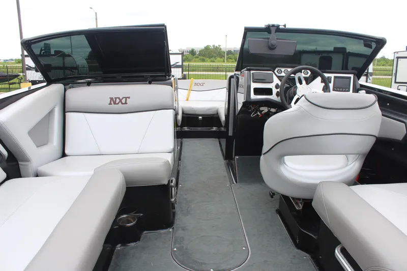 Slide: The Image of 2017 MasterCraft NXT22 boat interior with sleek seating and modern dashboard design. - 14