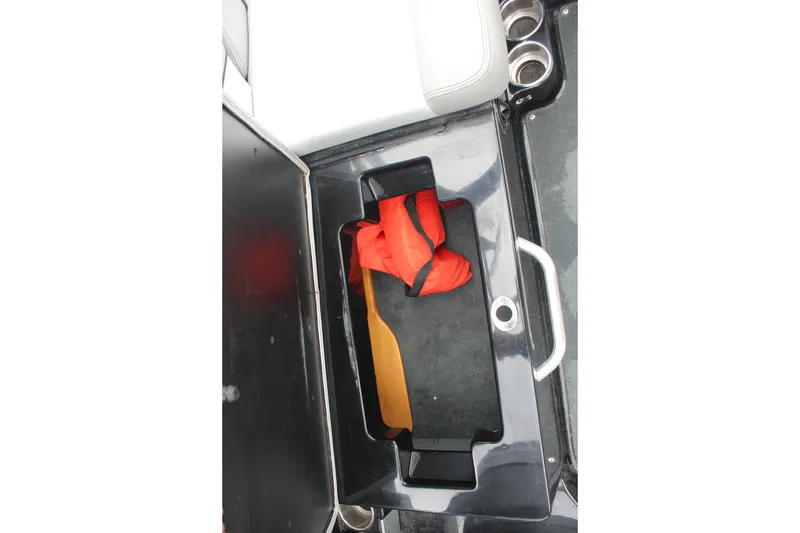 Slide: The Image of Storage compartment in 2017 MasterCraft NXT22 boat with life jacket and paddle. - 20