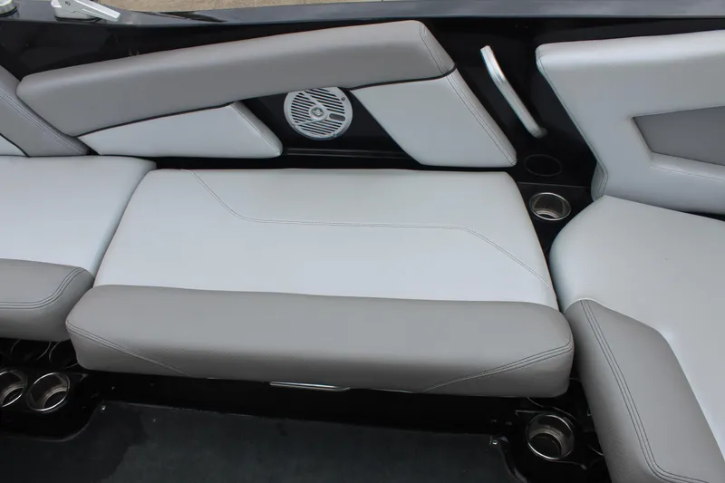 Slide: The Image of 2017 MasterCraft NXT22 interior seating with gray upholstery and integrated speaker. - 16