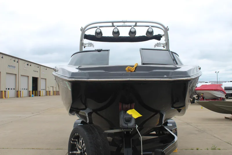 Slide: The Image of 2017 MasterCraft NXT22 boat on trailer, parked outside a warehouse. - 3