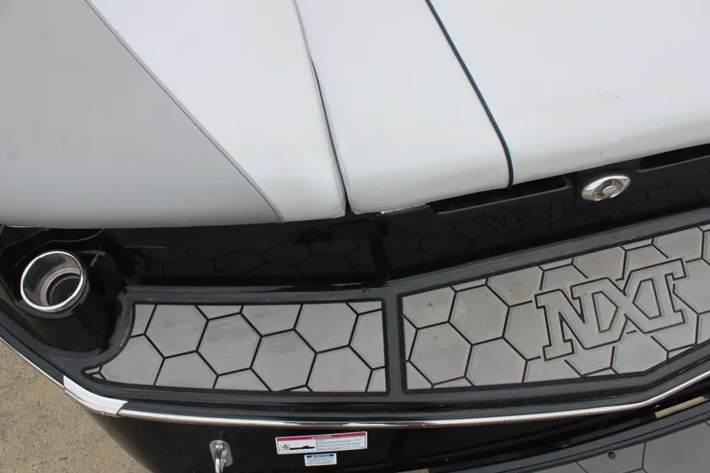 Slide: The Image of 2017 MasterCraft NXT22 boat with hexagonal pattern and sleek design details. - 12